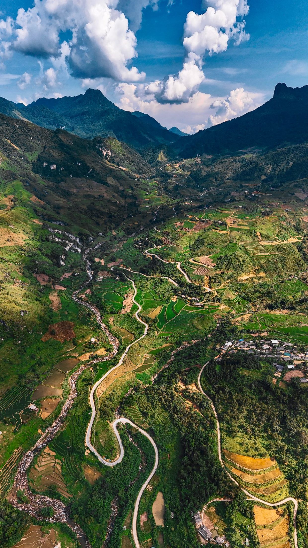 Discover breathtaking aerial scenery of Ha Giang, Vietnam, featuring lush valleys and winding roads. by Maxed-Raw-Pexels