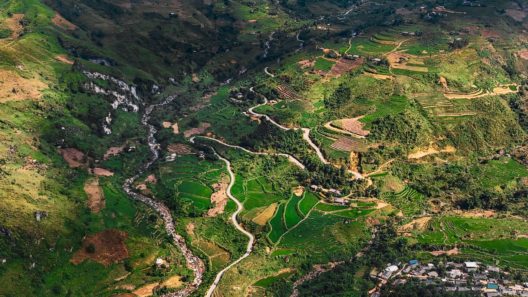 Discover breathtaking aerial scenery of Ha Giang, Vietnam, featuring lush valleys and winding roads. by Maxed-Raw-Pexels